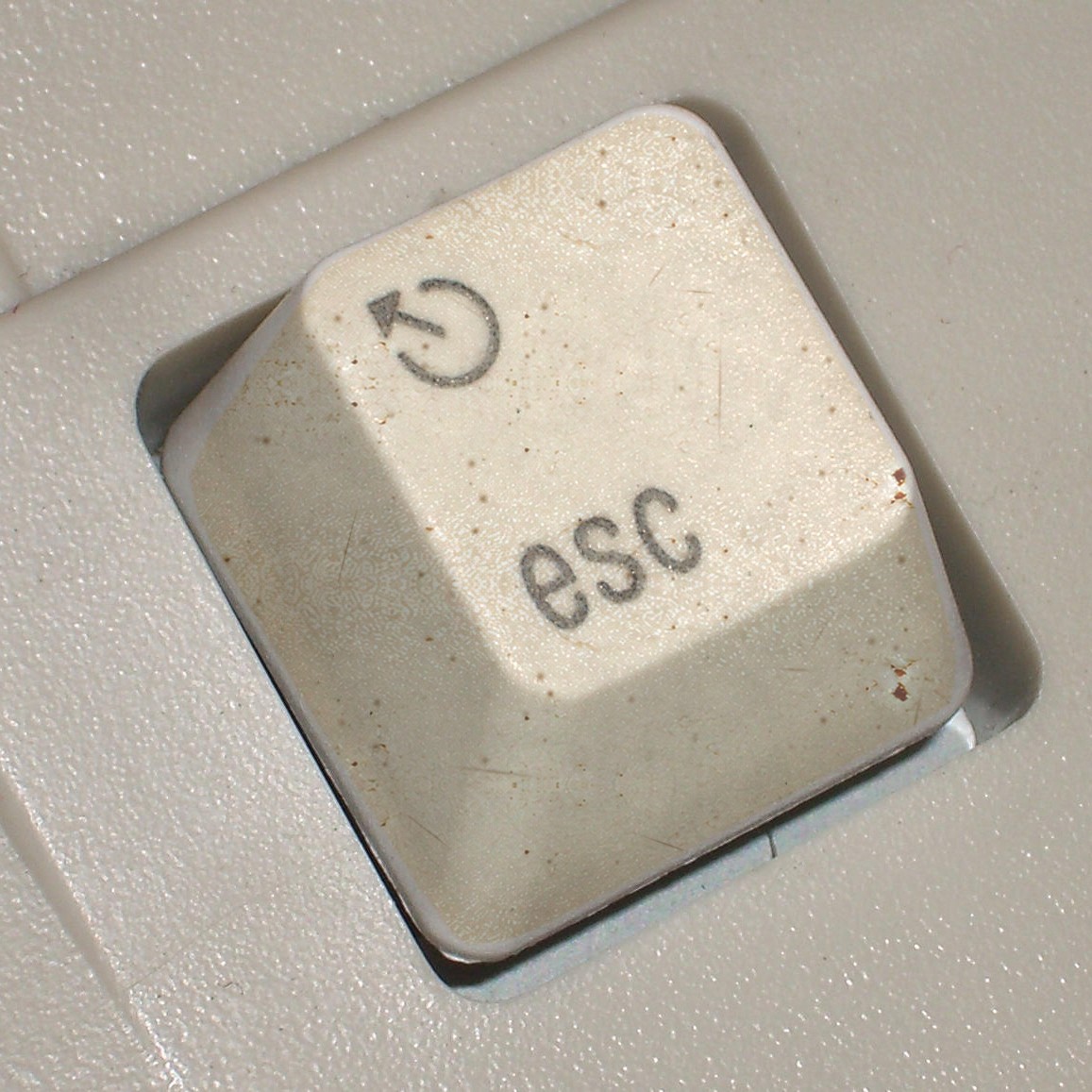 An old esc key, still sitting in its keyboard.